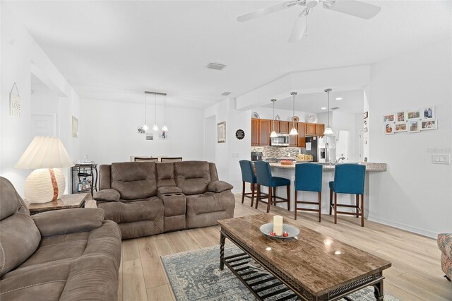 3554 NW 55th Cir, Ocala, FL 34482 - living area featuring light wood-type flooring, a ceiling fan, and a chandelier