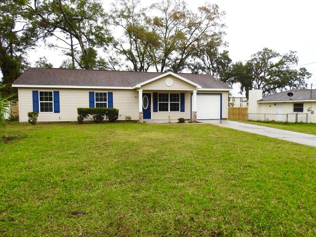 ranch-style home with a front yard and a garage