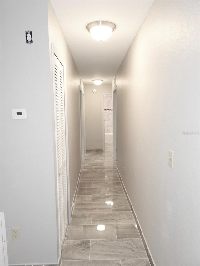 corridor featuring light tile floors