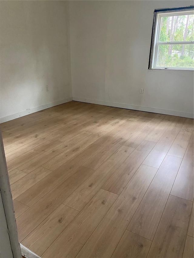 spare room with light hardwood / wood-style flooring