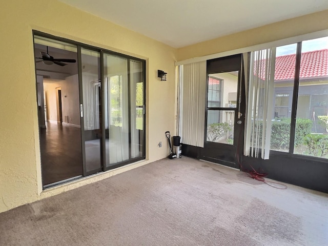 interior space with ceiling fan and a wealth of natural light