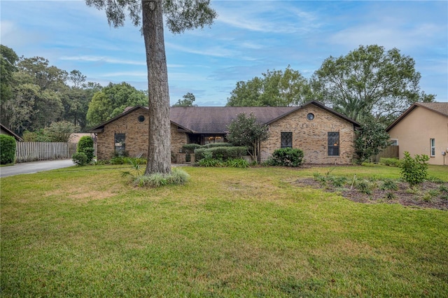 ranch-style home featuring a front yard