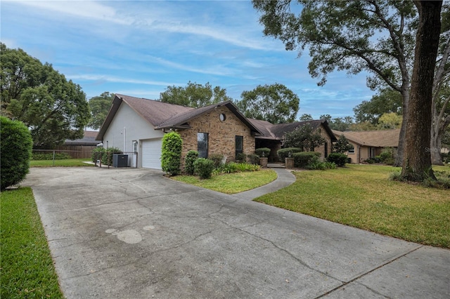 single story home featuring a front lawn, central AC, and a garage