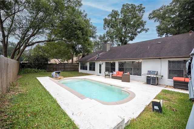 view of swimming pool with a patio area, grilling area, and a lawn