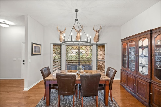 dining space with a chandelier and hardwood / wood-style floors