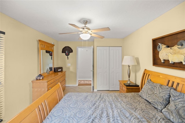 bedroom with a closet, ceiling fan, and light tile floors