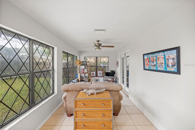 interior space featuring ceiling fan and light tile floors