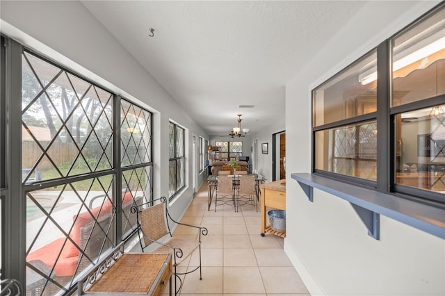 sunroom with a chandelier