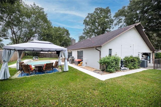 view of property exterior with a gazebo, central AC, a yard, and a patio