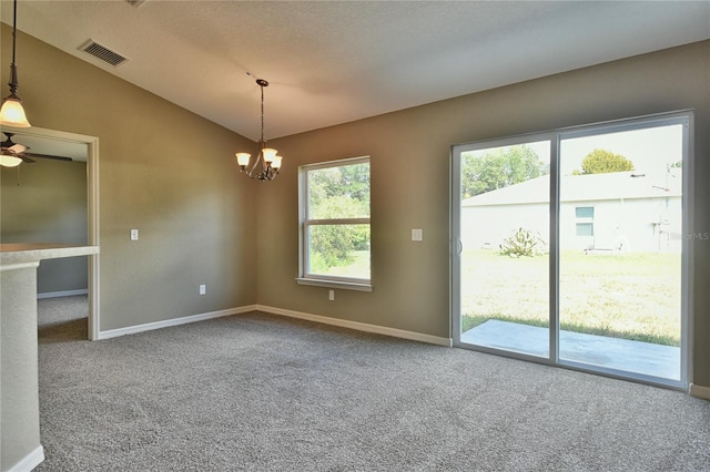 unfurnished room with a textured ceiling, light colored carpet, vaulted ceiling, and ceiling fan with notable chandelier