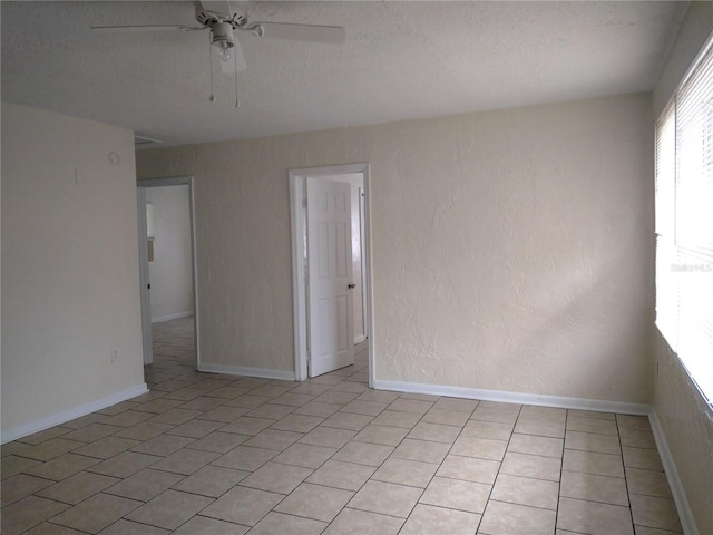2008 NW 14th St, Ocala, FL 34475 - spare room with a textured ceiling, a ceiling fan, and light tile patterned flooring