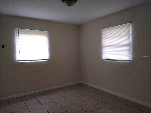 2008 NW 14th St, Ocala, FL 34475 - unfurnished room featuring light tile patterned floors and baseboards