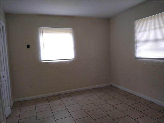 2008 NW 14th St, Ocala, FL 34475 - spare room featuring light tile patterned floors and baseboards