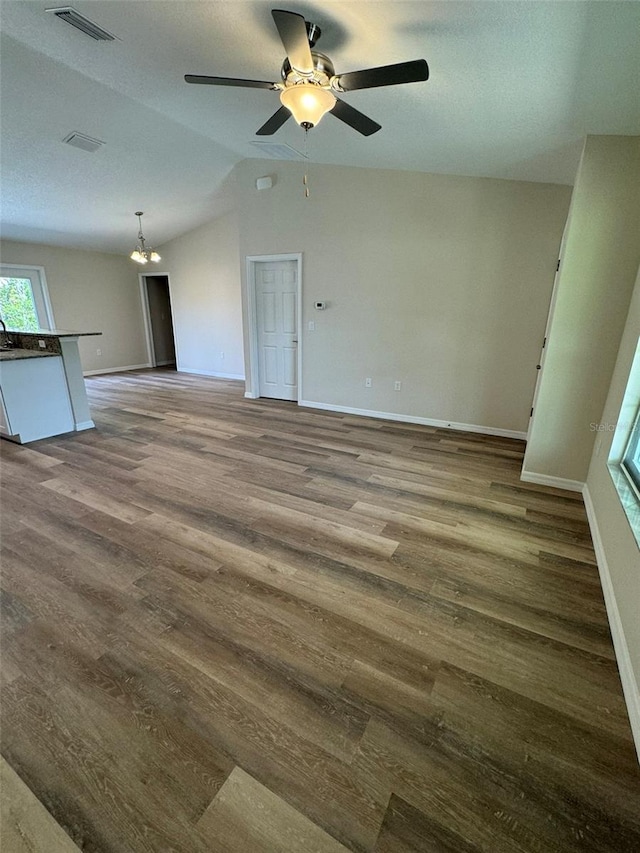 spare room with lofted ceiling, hardwood / wood-style floors, and ceiling fan