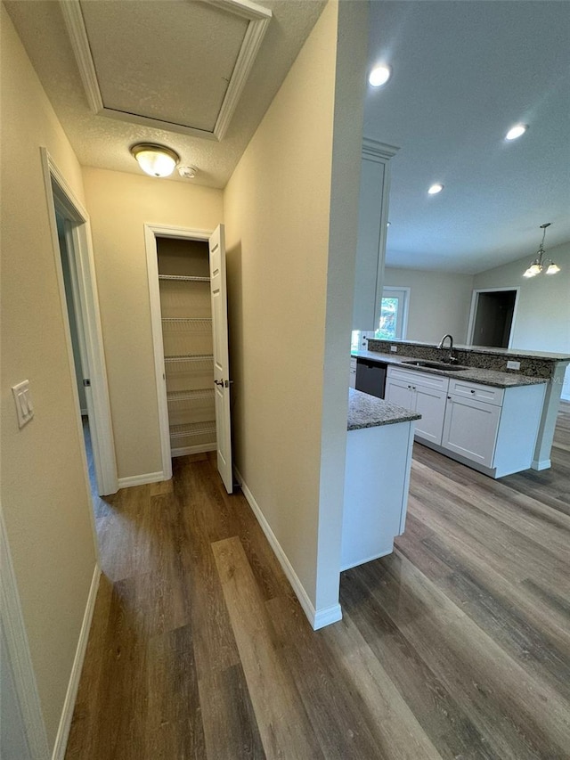 hallway with hardwood / wood-style floors and sink