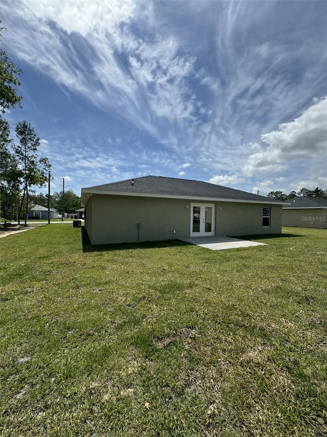 back of house with french doors, a yard, and a patio area