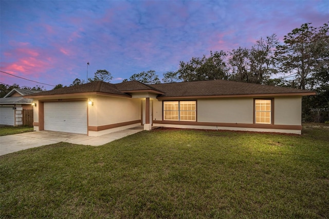 view of front of property featuring a lawn and a garage