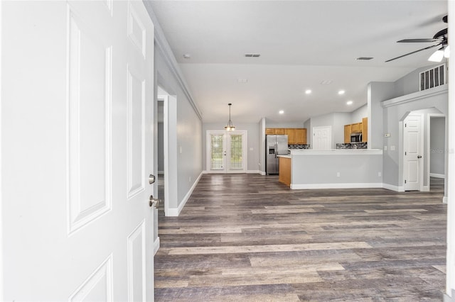 unfurnished living room with ceiling fan and dark wood-type flooring