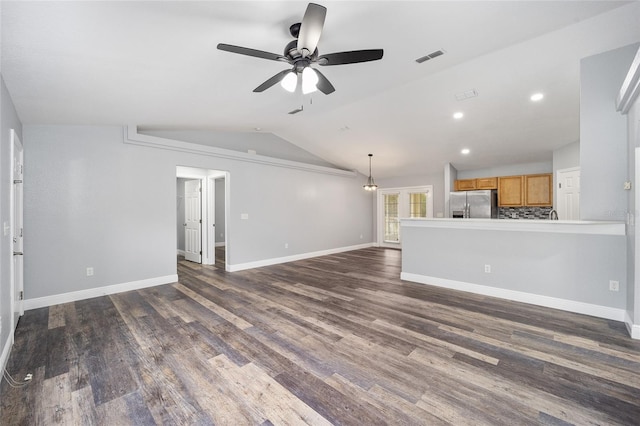 unfurnished living room with ceiling fan, dark hardwood / wood-style flooring, and lofted ceiling