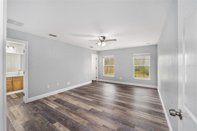 spare room with a textured ceiling, dark hardwood / wood-style floors, and ceiling fan