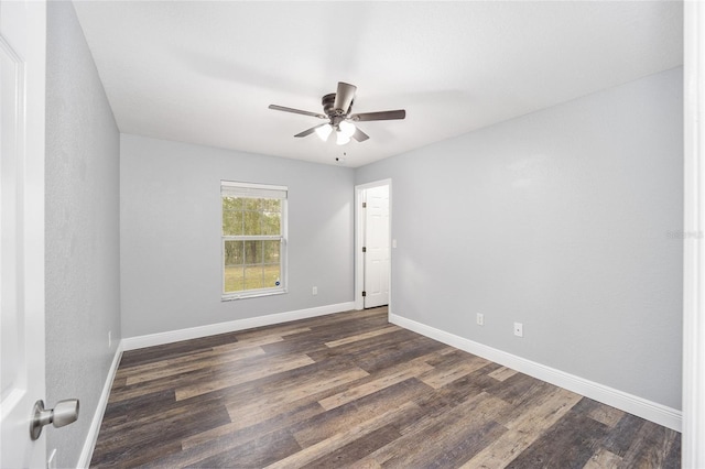 spare room with ceiling fan and dark hardwood / wood-style floors