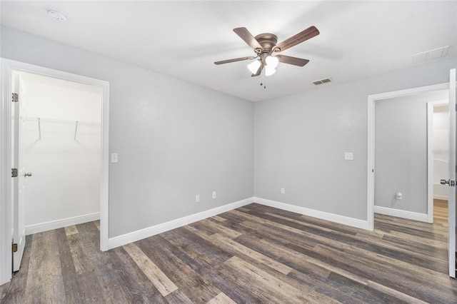 spare room with ceiling fan and dark hardwood / wood-style flooring