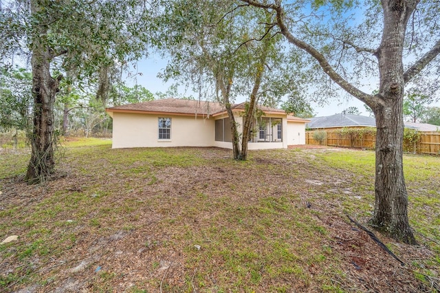 back of house featuring a yard