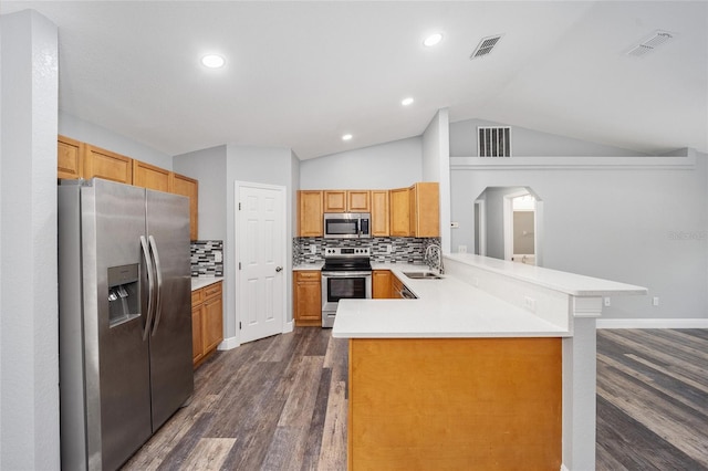 kitchen with sink, dark hardwood / wood-style flooring, kitchen peninsula, decorative backsplash, and appliances with stainless steel finishes