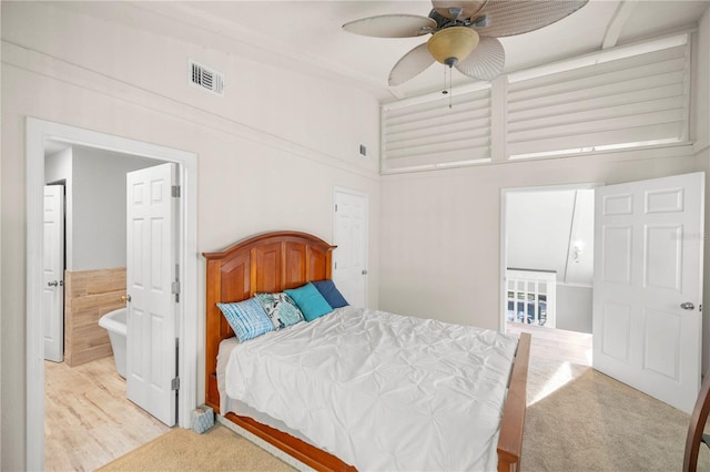 bedroom featuring ceiling fan, a towering ceiling, and light hardwood / wood-style floors