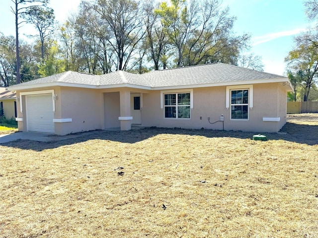 single story home with a garage and a front yard