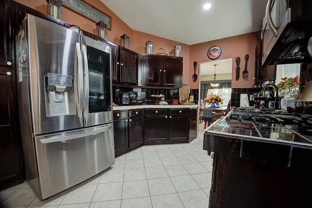 kitchen featuring stainless steel fridge with ice dispenser, dark brown cabinets, light tile patterned floors, and decorative light fixtures