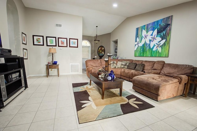 living room featuring light tile patterned floors and vaulted ceiling