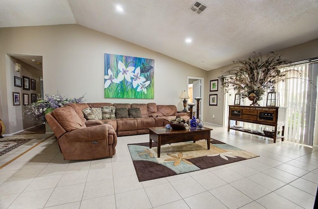 tiled living room featuring a textured ceiling and vaulted ceiling