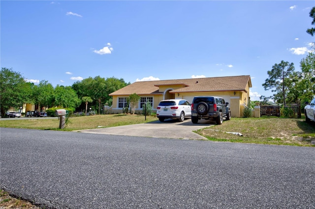 view of front of property featuring a garage and a front lawn