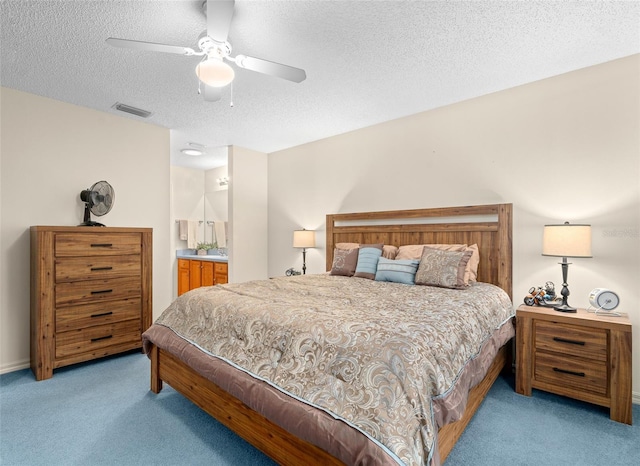 carpeted bedroom featuring a textured ceiling and ceiling fan