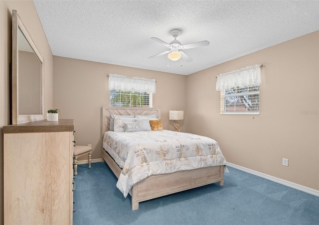 bedroom with carpet flooring, a textured ceiling, and ceiling fan