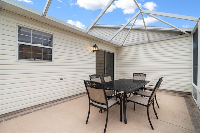 view of patio / terrace featuring glass enclosure