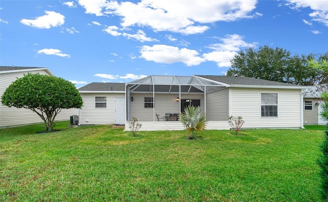 back of house with a yard, central AC unit, and glass enclosure