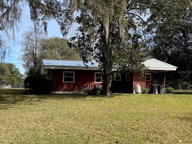 rear view of property with a lawn