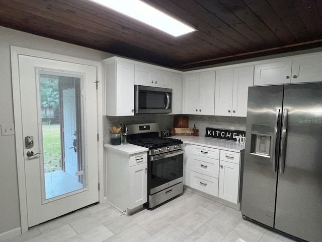 kitchen with white cabinets, backsplash, wooden ceiling, and stainless steel appliances