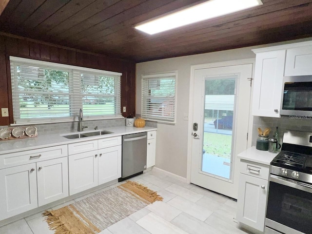 kitchen with light tile floors, wood ceiling, sink, and stainless steel appliances