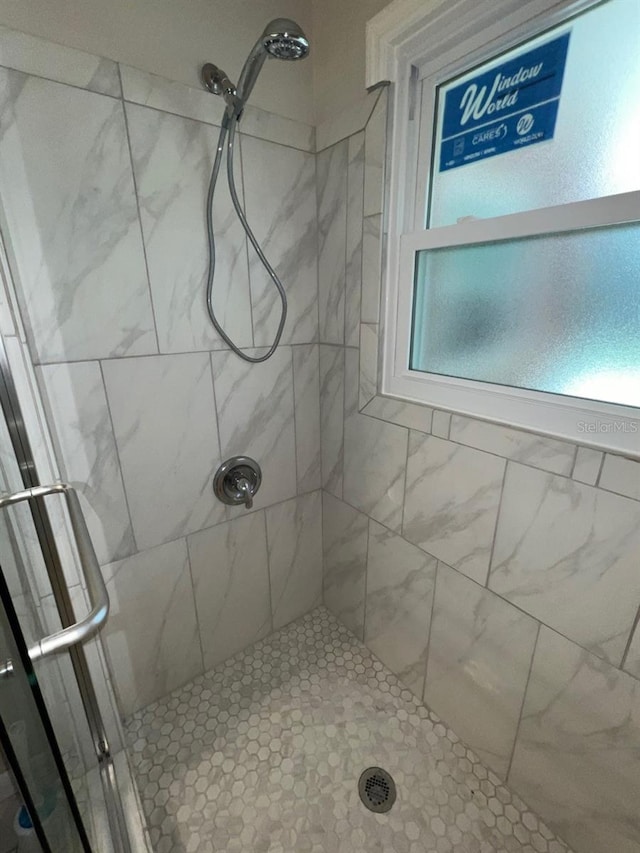 bathroom with tiled shower