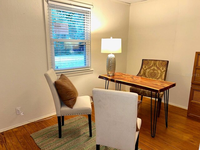 sitting room featuring crown molding, dark hardwood / wood-style flooring, and a healthy amount of sunlight