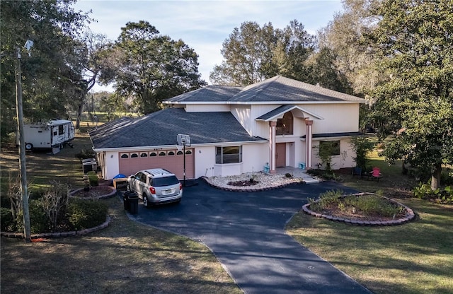 view of front facade with a garage and a front lawn