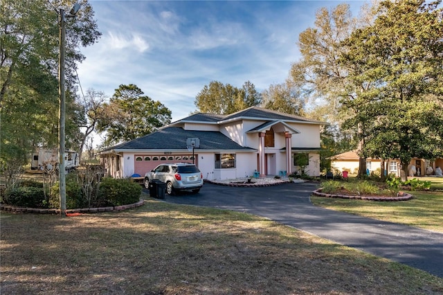 view of front of property with a garage and a front yard