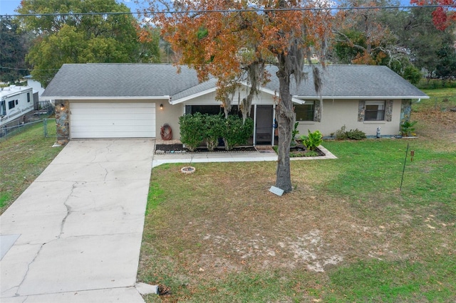 ranch-style house featuring a front lawn and a garage