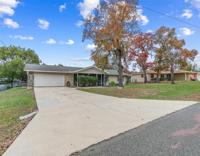 ranch-style home with a front lawn and a garage