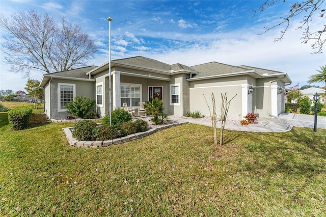 view of front of property featuring a front lawn and a garage