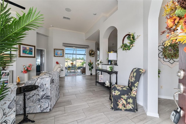 interior space with light tile floors and crown molding