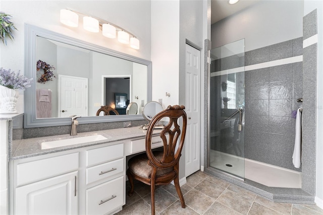 bathroom with large vanity, tile floors, and a shower with shower door